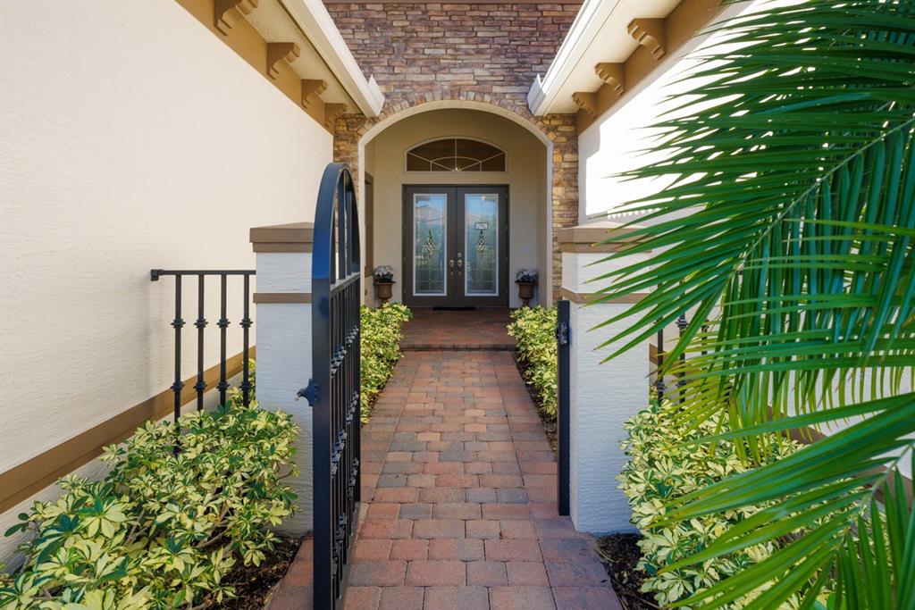 21864 Southwest Tivolo Way Port St. Lucie, FL 34986 - Photo 7 of 40 a view of entrance gate of a house