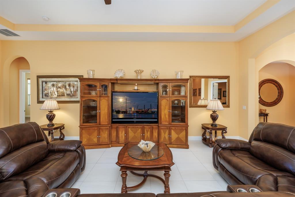 21864 Southwest Tivolo Way Port St. Lucie, FL 34986 - Photo 10 of 40 a living room with furniture and a flat screen tv