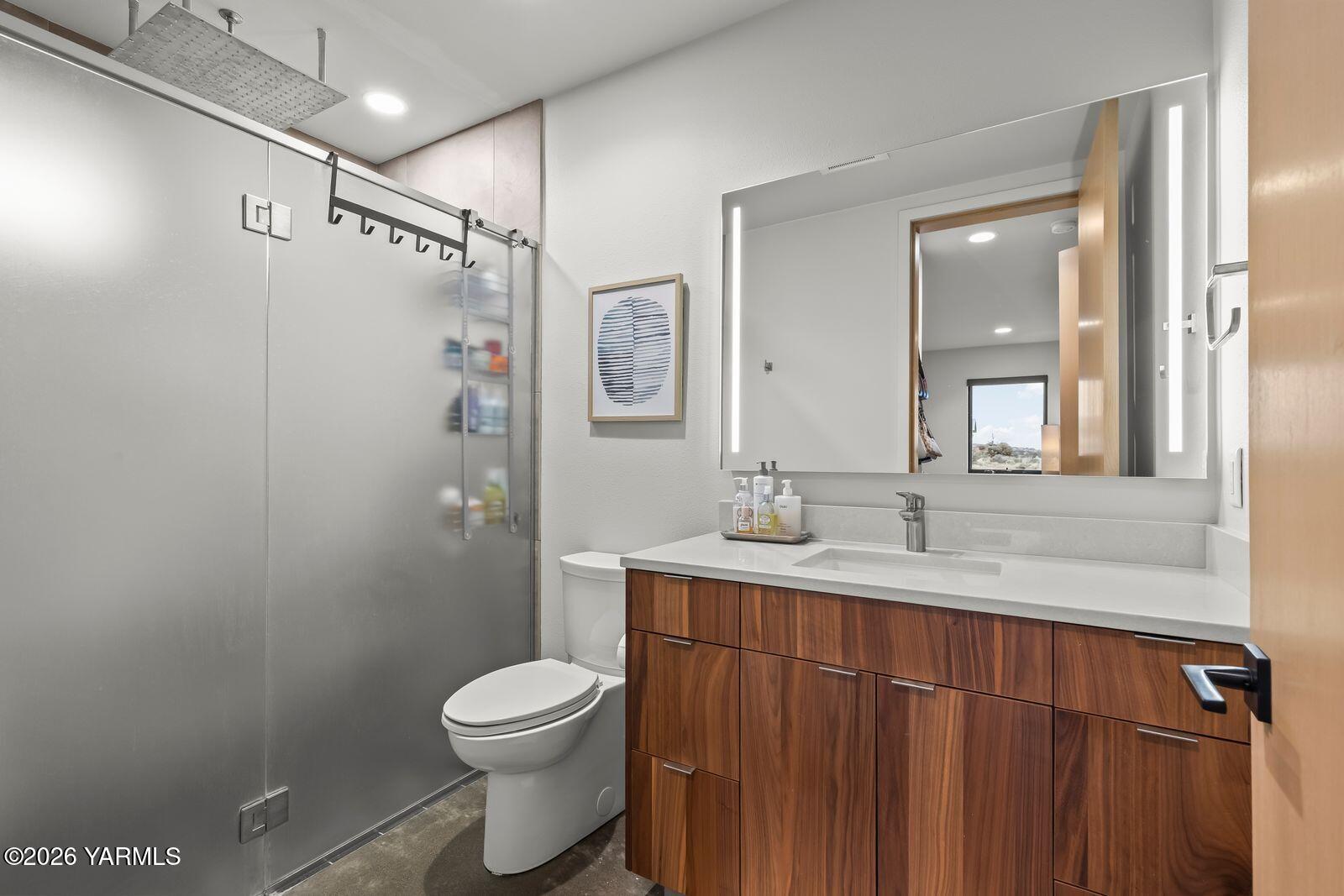 13990 Marble Road Yakima, WA 98908 - Photo 39 of 60 a bathroom with a granite countertop sink toilet a large mirror and shower