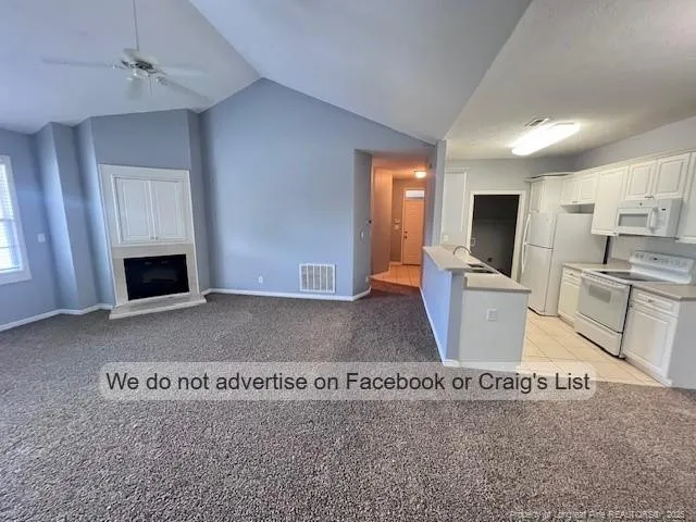 a view of kitchen with sink microwave and refrigerator