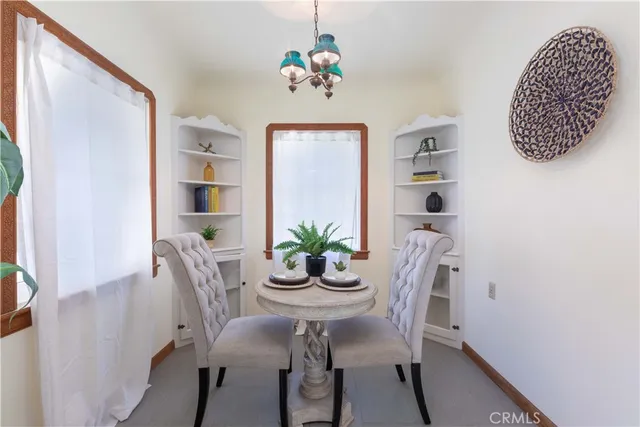 a view of a dining room with furniture and chandelier