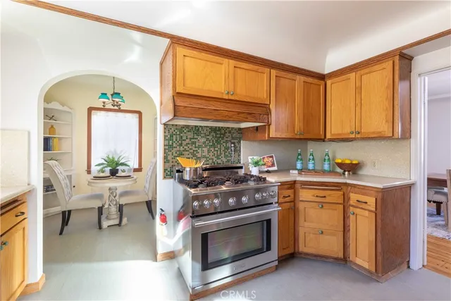 a kitchen with a stove and white cabinets