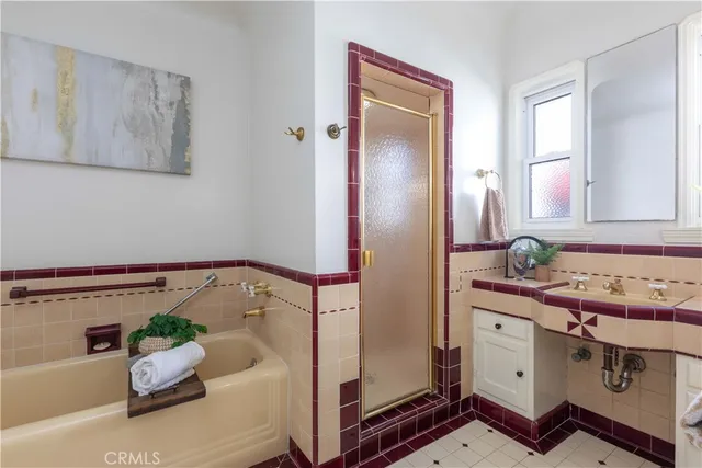 a bathroom with a tub sink and mirror