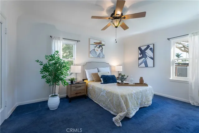 a bed room with furniture and a potted plant
