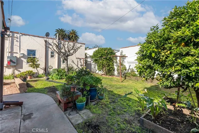 a view of a garden with a building in the background