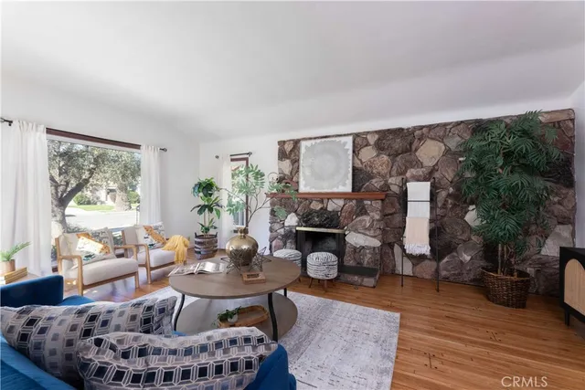 a living room with furniture a fireplace and a table