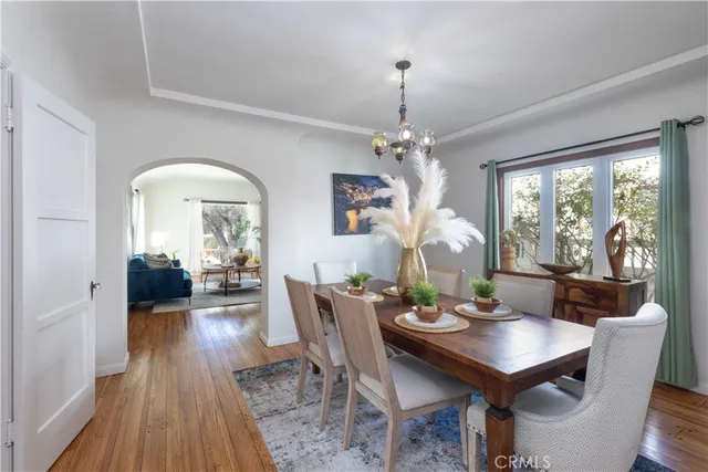 a view of a dining room with furniture window and wooden floor