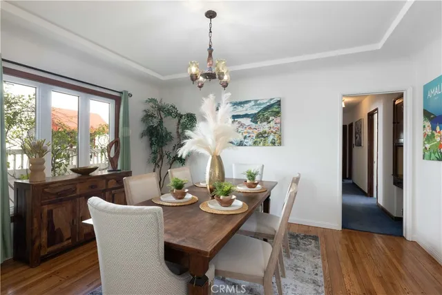 a view of a dining room with furniture window and wooden floor