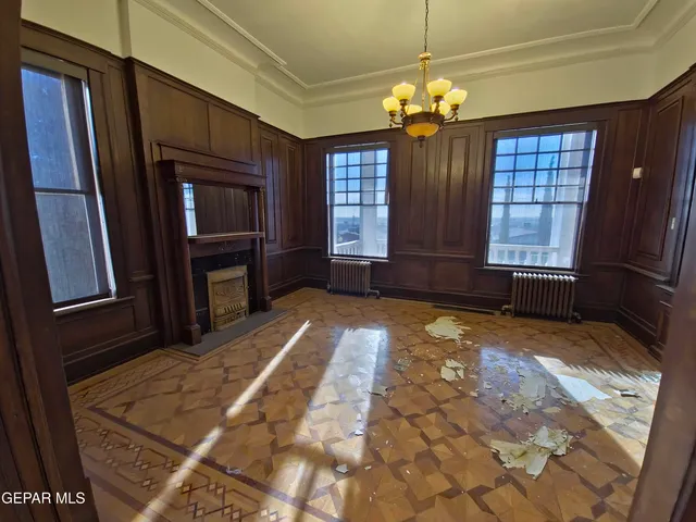 a view of a livingroom with a furniture an empty shelves and dishwasher