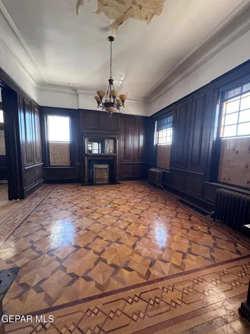 a room with wooden floor and window