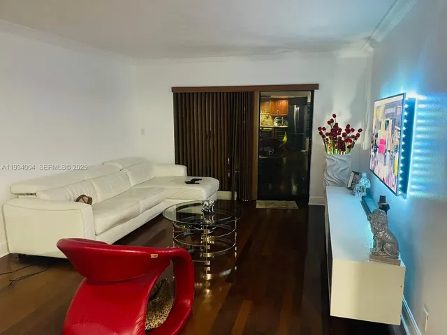 a view of a hallway with furniture and wooden floor
