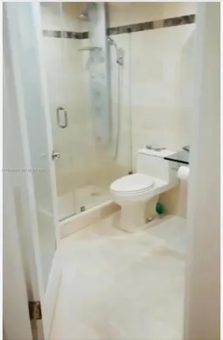 a bathroom with a toilet and shower