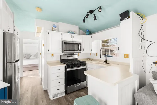 a open kitchen with stainless steel appliances kitchen island granite countertop a sink and cabinets