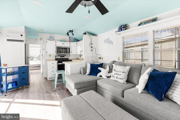 a living room with patio furniture and a flat screen tv