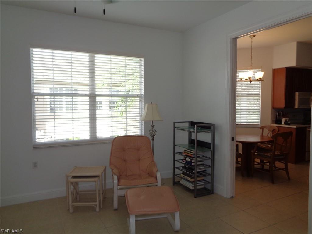 709 Regency Reserve Circle, Unit 6003 Naples, FL 34119 - Photo 16 of 44 Living area with light tile patterned floors and a chandelier