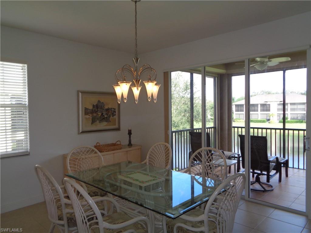709 Regency Reserve Circle, Unit 6003 Naples, FL 34119 - Photo 17 of 44 a view of a dining room with furniture window and outside view