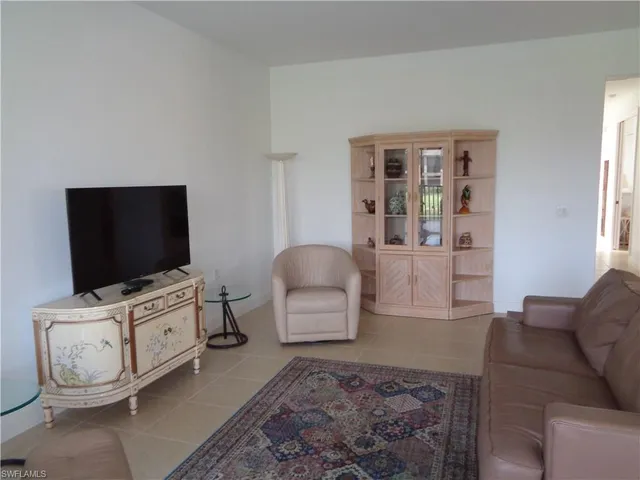 a room with a flat screen tv and a window