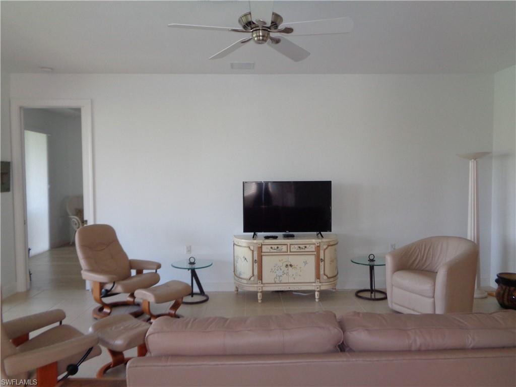 709 Regency Reserve Circle, Unit 6003 Naples, FL 34119 - Photo 20 of 44 a living room with furniture and a flat screen tv