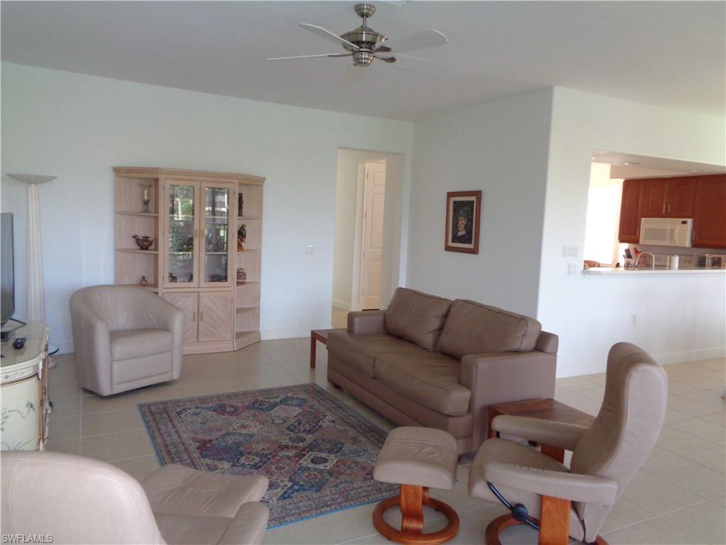 709 Regency Reserve Circle, Unit 6003 Naples, FL 34119 - Photo 21 of 44 a living room with furniture and wooden floor