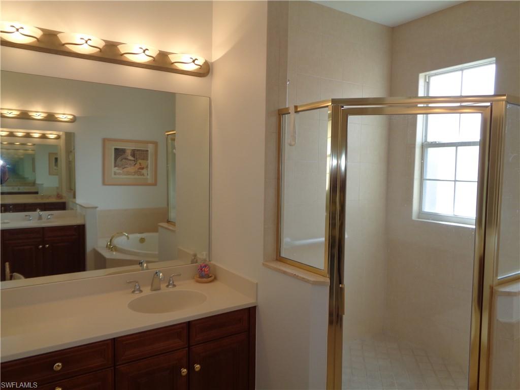709 Regency Reserve Circle, Unit 6003 Naples, FL 34119 - Photo 28 of 44 a bathroom with a double vanity sink toilet and mirror