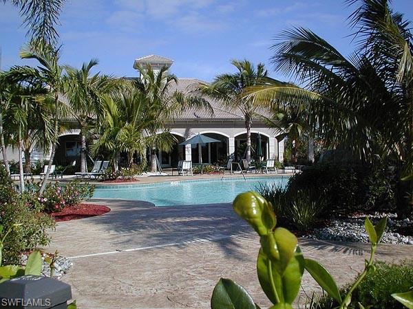 709 Regency Reserve Circle, Unit 6003 Naples, FL 34119 - Photo 3 of 44 Community pool featuring a patio area