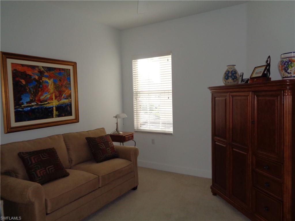 709 Regency Reserve Circle, Unit 6003 Naples, FL 34119 - Photo 34 of 44 a living room with furniture and a closet
