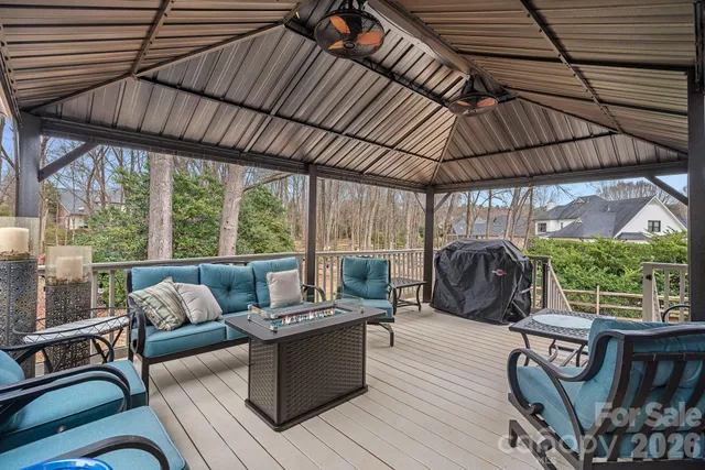 a view of a patio with couches chairs potted plants and a barbeque