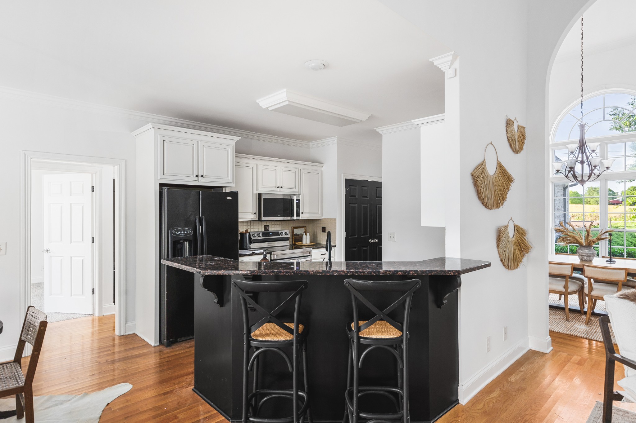 852 Bradshaw Road Lebanon, TN 37087 - Photo 12 of 41 a kitchen with stainless steel appliances kitchen island granite countertop a refrigerator a stove a sink and a dining table with wooden floor