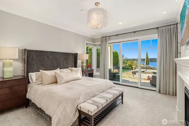 a bedroom with a bed mirror and a large window