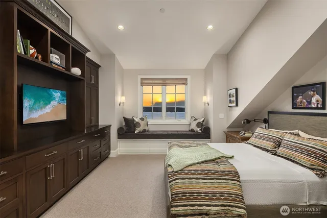 a spacious bedroom with a bed and a flat screen tv