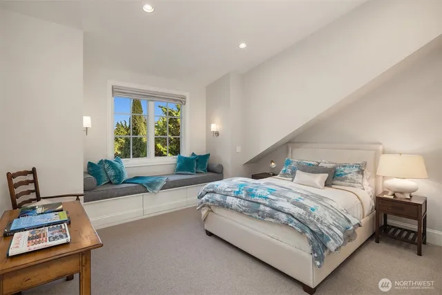 a bedroom with a bed window and couch