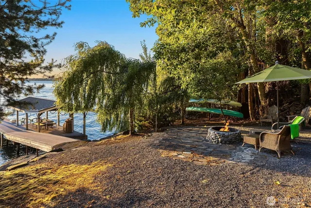 a view of a back yard with flower plants and tree s