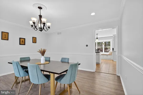 a view of a dining room with furniture wooden floor and chandelier