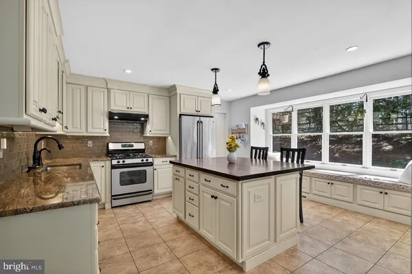 a kitchen with stainless steel appliances granite countertop a sink and stove
