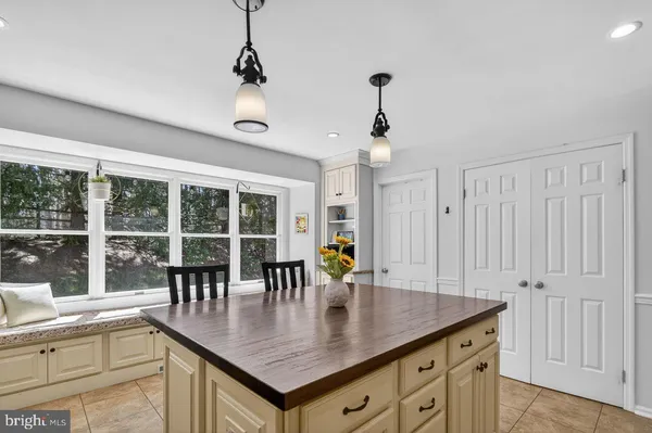 a view of a kitchen counter space with furniture and windows