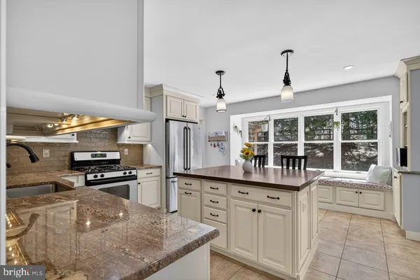 a kitchen with stainless steel appliances granite countertop a sink and a stove