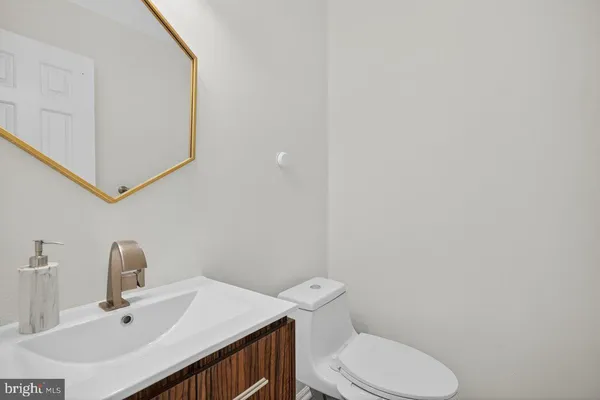 a bathroom with a sink a toilet and mirror