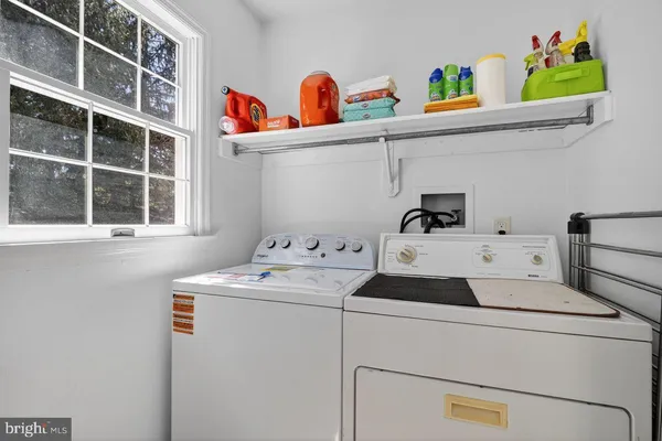 a utility room with dryer washer and a window