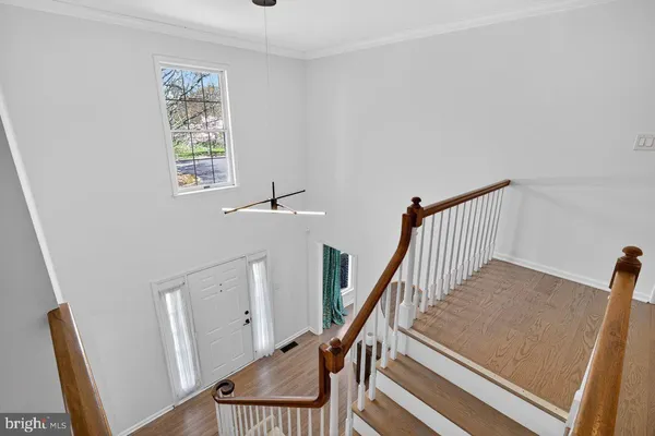 a view of staircase with white walls and a window