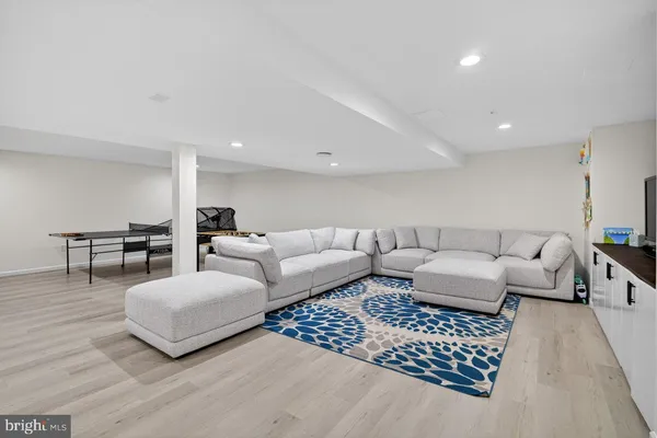 a living room with furniture a piano and a flat screen tv