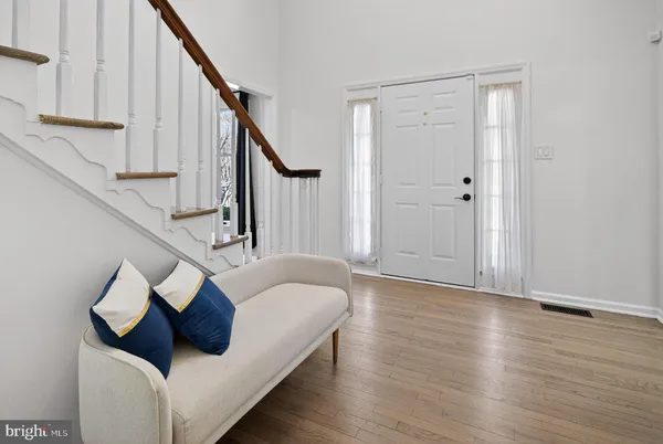 a living room with wooden floor and stairs