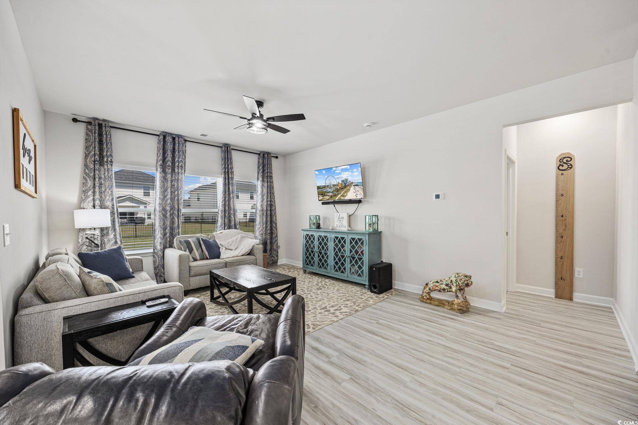 2412 Copper Mdw Loop Longs, SC 29568 - Photo 12 of 40 Living room featuring wood finished floors and a ceiling fan