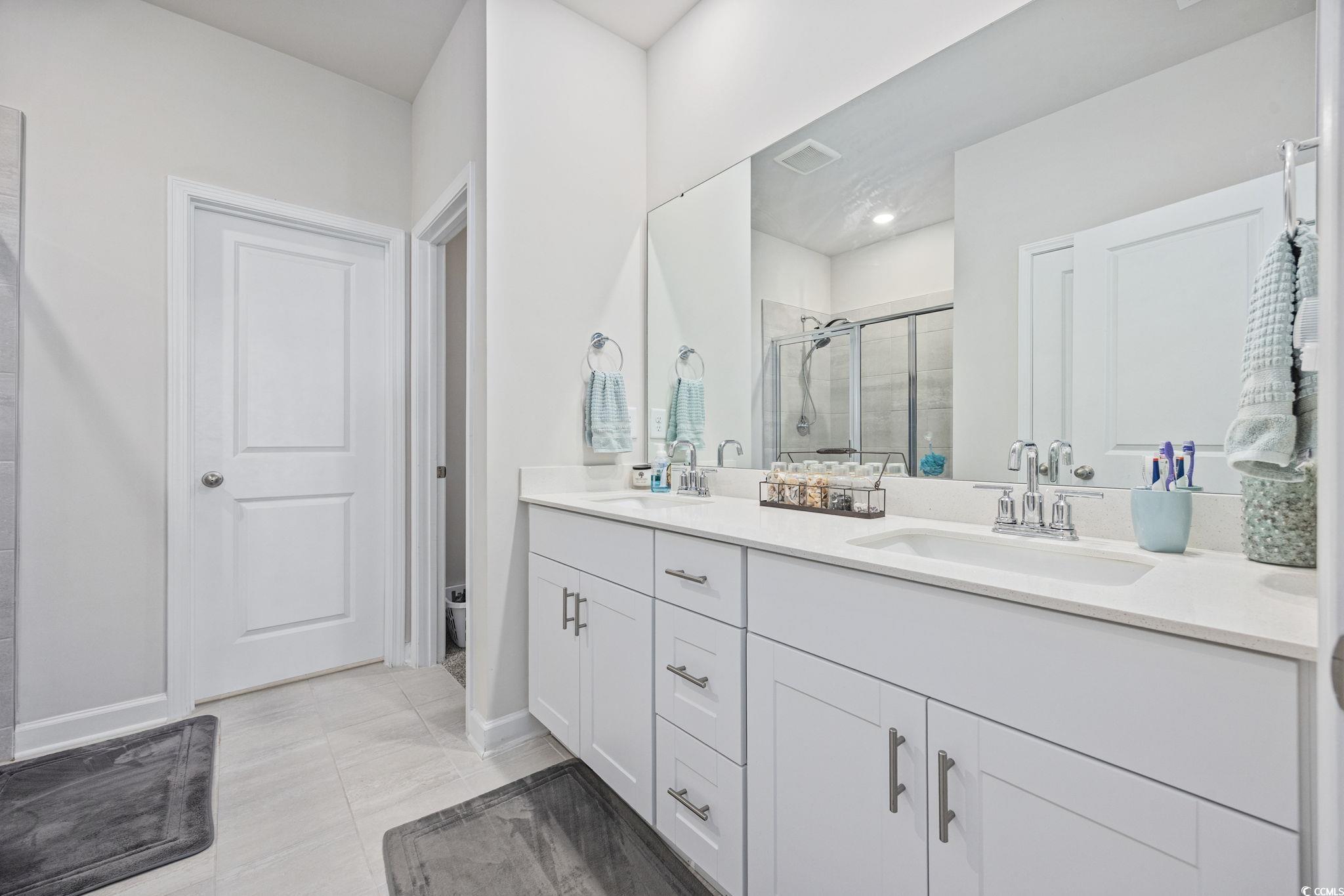 2412 Copper Mdw Loop Longs, SC 29568 - Photo 17 of 40 Full bathroom with double vanity, a shower stall, and light tile patterned flooring