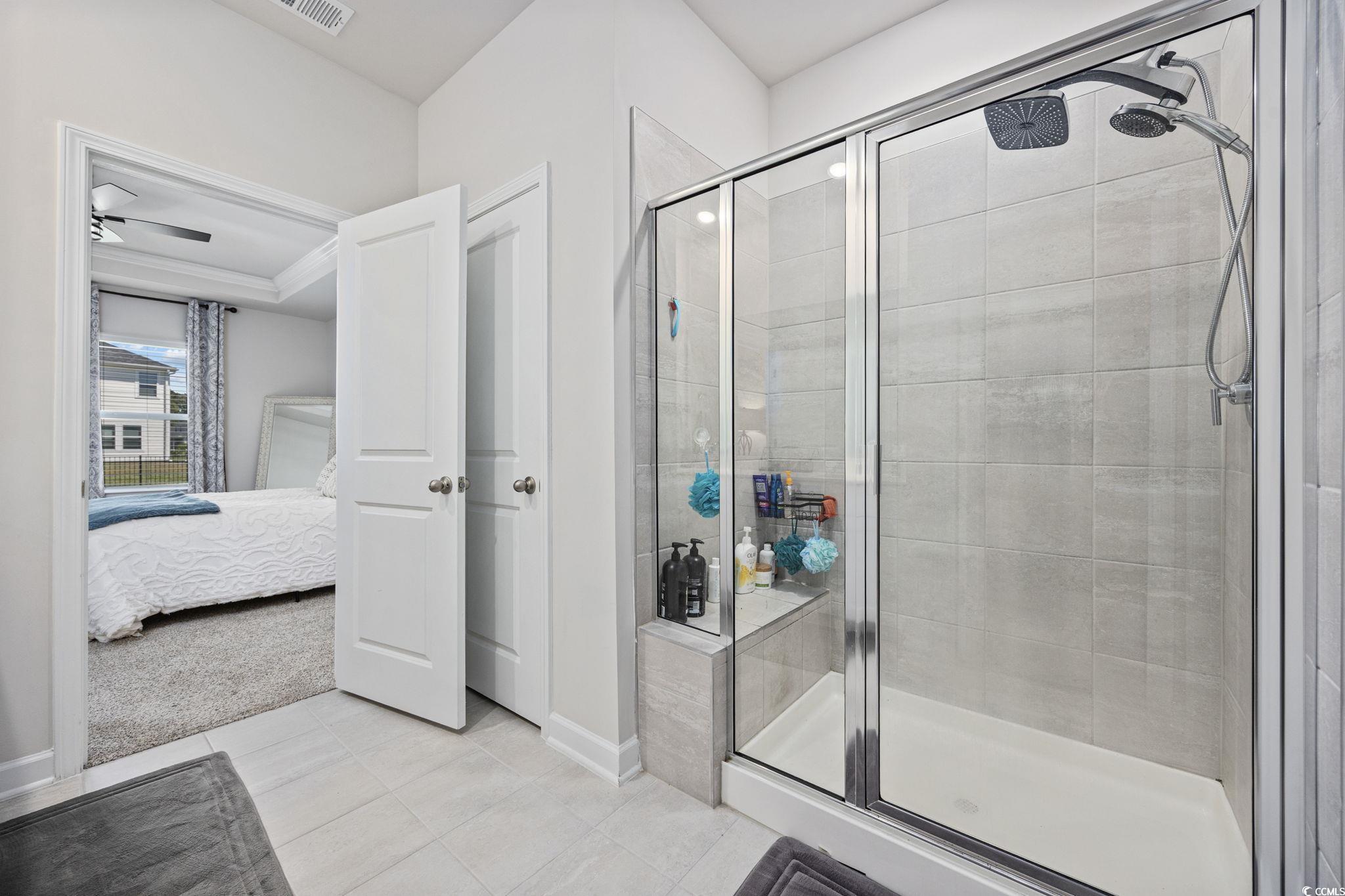 2412 Copper Mdw Loop Longs, SC 29568 - Photo 18 of 40 Ensuite bathroom featuring a stall shower and light tile patterned floors