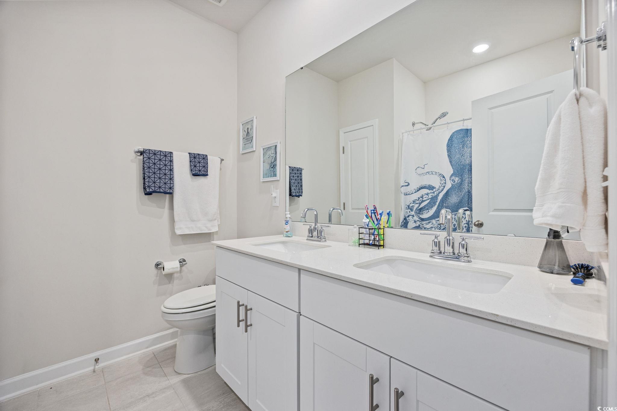 2412 Copper Mdw Loop Longs, SC 29568 - Photo 19 of 40 Bathroom featuring double vanity, light tile patterned flooring, and a shower with shower curtain