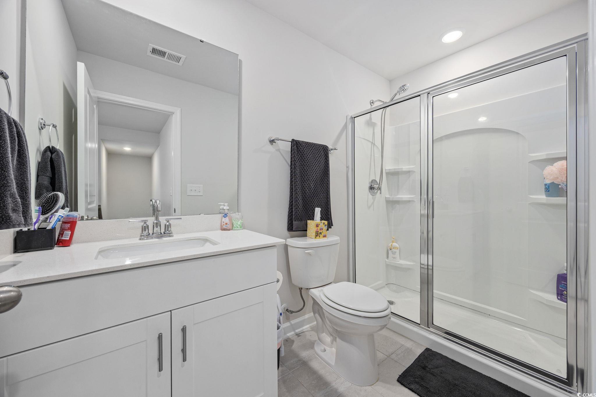 2412 Copper Mdw Loop Longs, SC 29568 - Photo 24 of 40 Full bathroom featuring a stall shower, vanity, light tile patterned floors, and recessed lighting