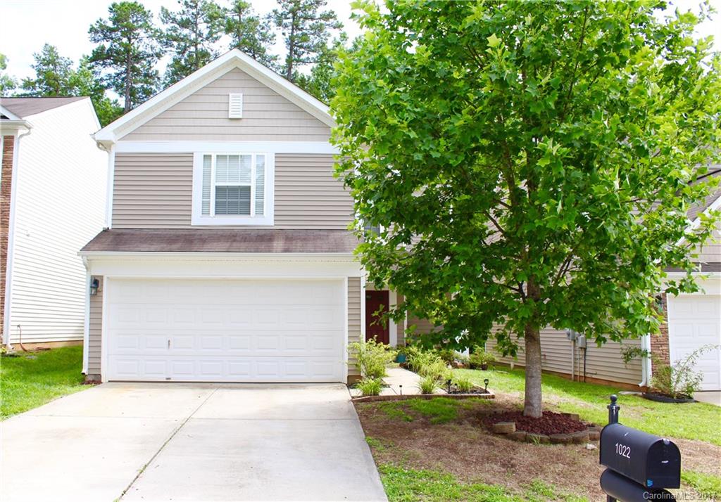 1022 Mearn Road Charlotte, NC 28216 - Photo 1 of 15 a front view of a house with a yard and garage