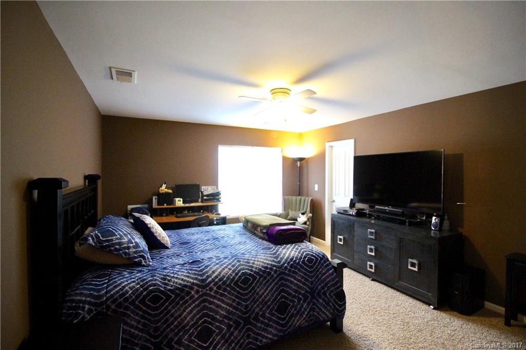 1022 Mearn Road Charlotte, NC 28216 - Photo 12 of 15 a bedroom with a bed and a flat tv screen on dresser