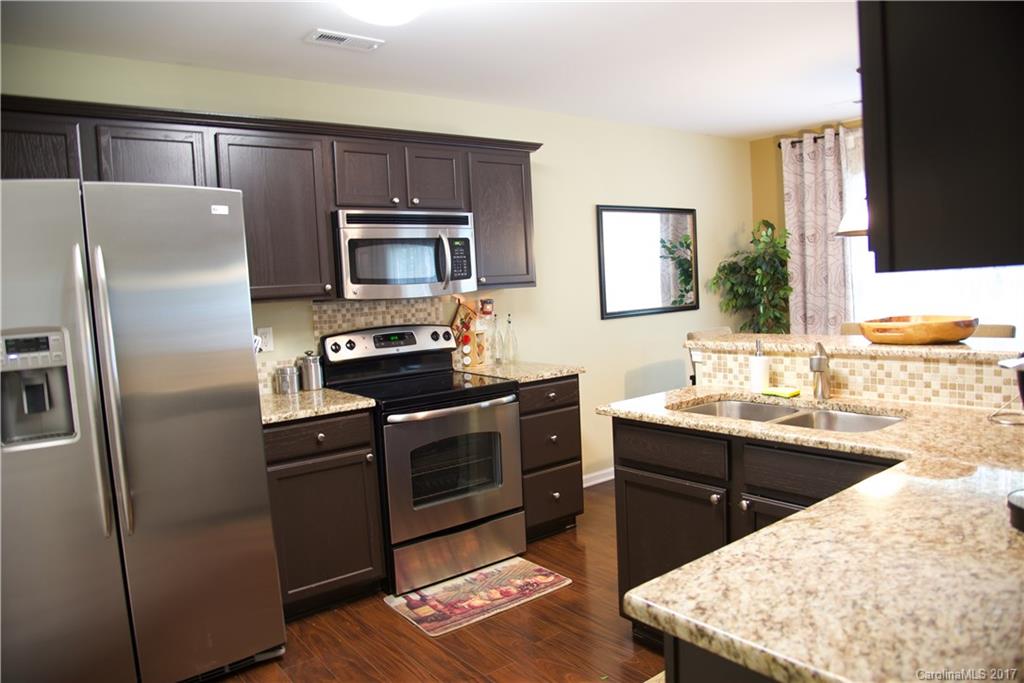 1022 Mearn Road Charlotte, NC 28216 - Photo 6 of 15 a kitchen with a sink stove and refrigerator