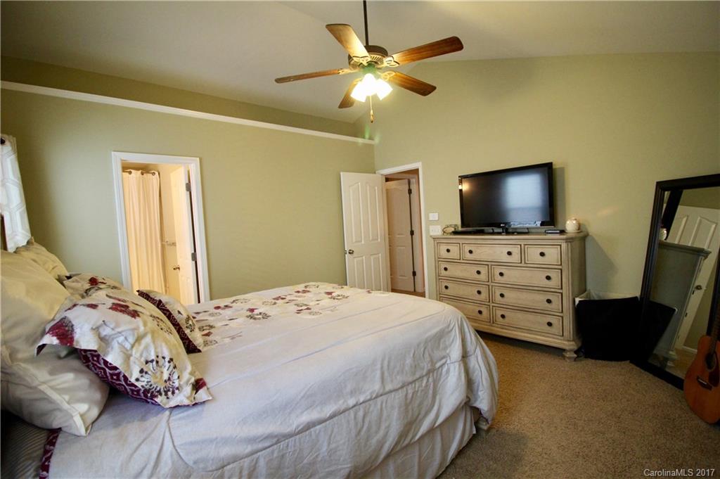 1022 Mearn Road Charlotte, NC 28216 - Photo 9 of 15 a bedroom with a bed and a flat screen tv on the dresser